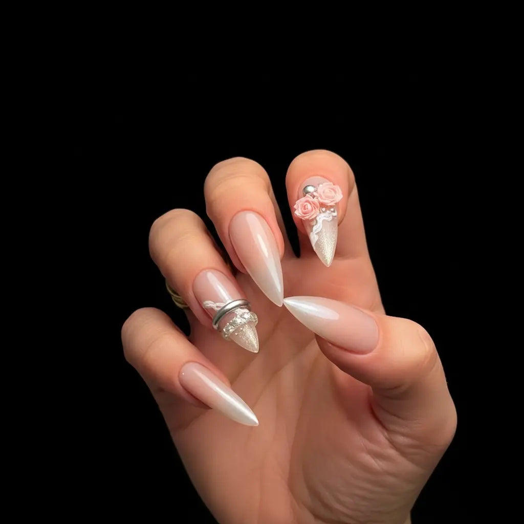 Soft blush nude stiletto press-on nails with 3D floral accents, lace detailing, and crystal embellishments.