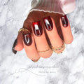 Luxury wine-red glass effect press-on nails with high-gloss finish on short square nails.