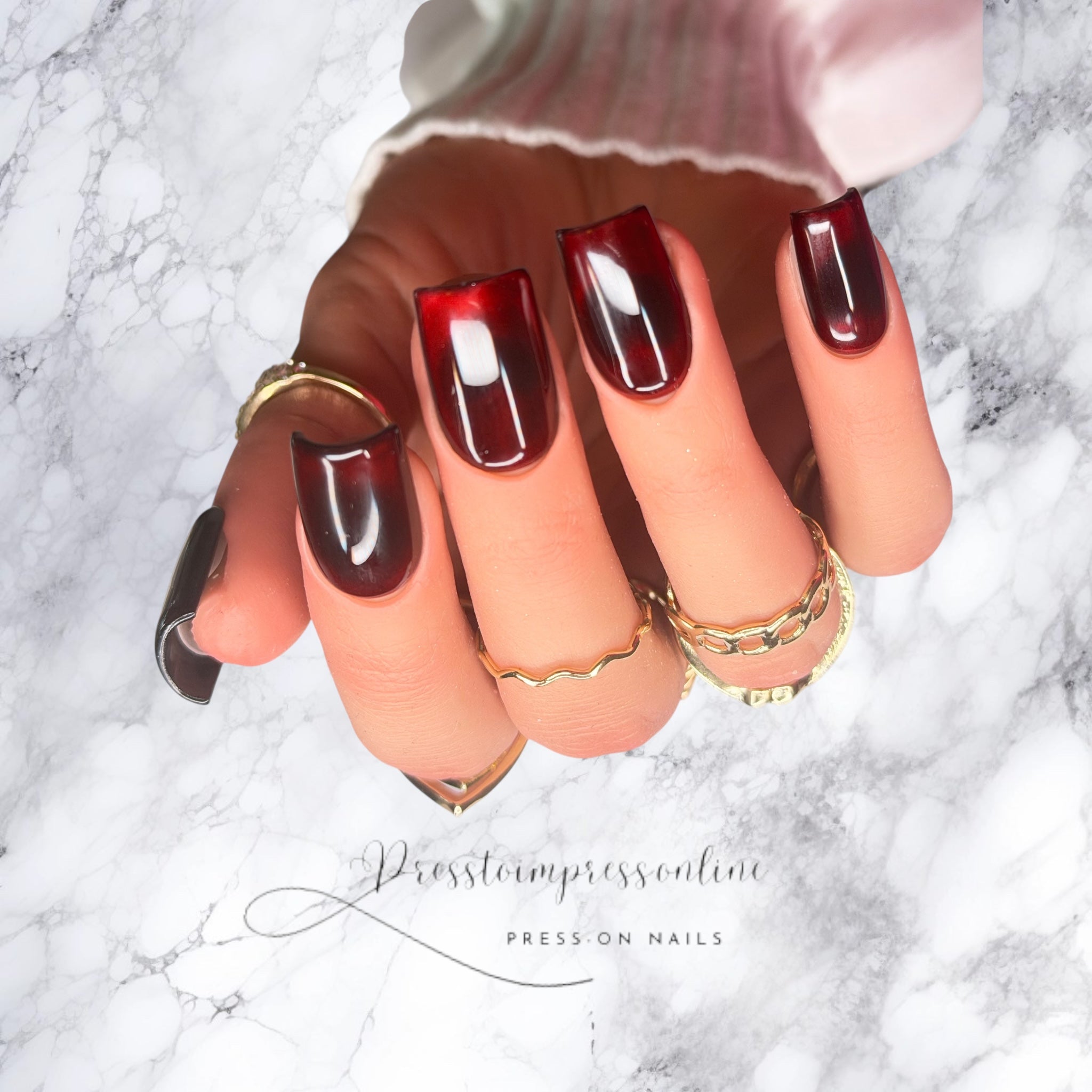 Luxury wine-red glass effect press-on nails with high-gloss finish on short square nails.