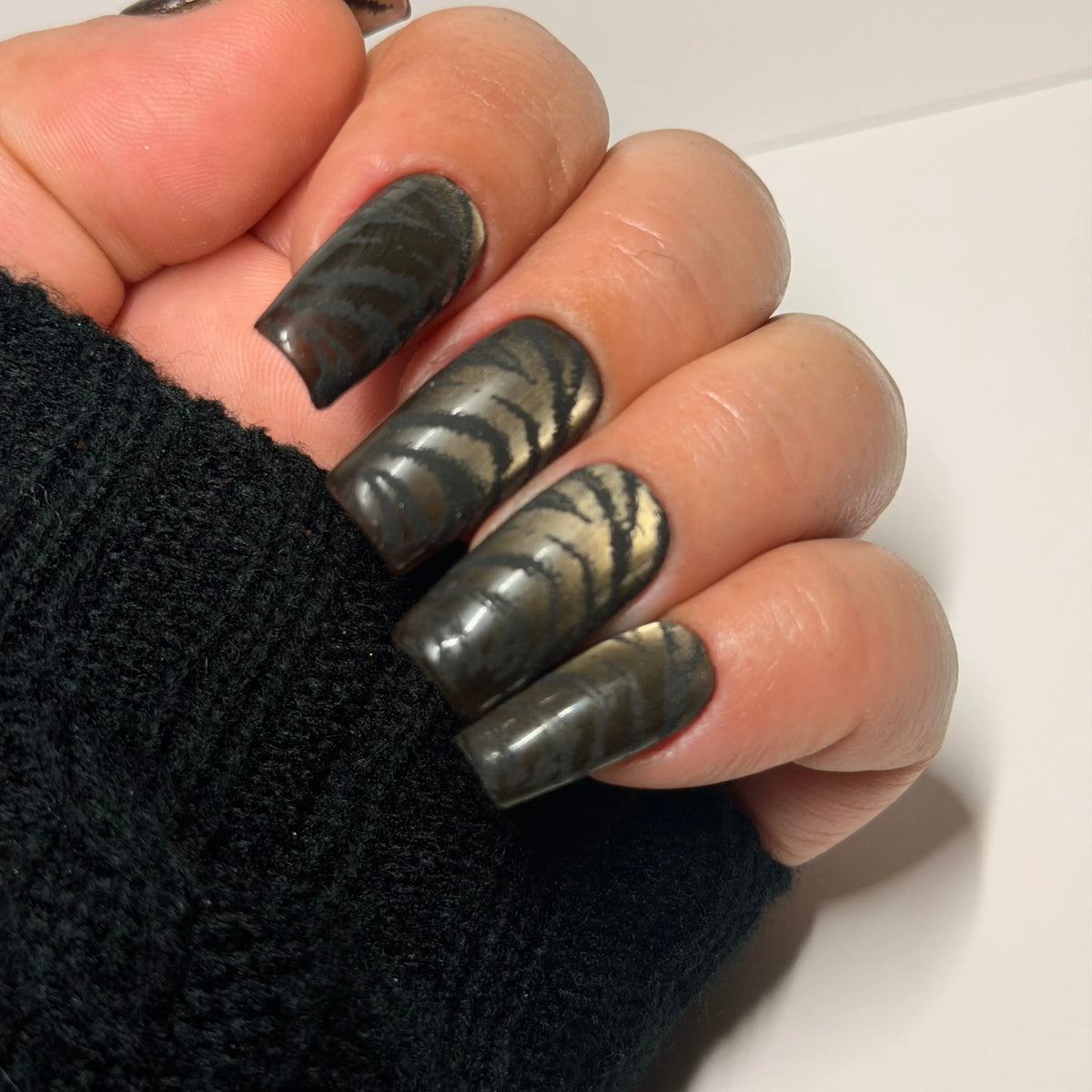 Burnished Smoke handmade press-on nails with smoky brown and charcoal abstract design and luminous cat-eye gel effect