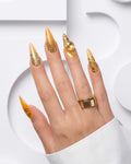 Luxury medium almond press-on nails with translucent amber glass French tips, elegant animal-print accents, and gold detailing in a high-gloss gel finish.