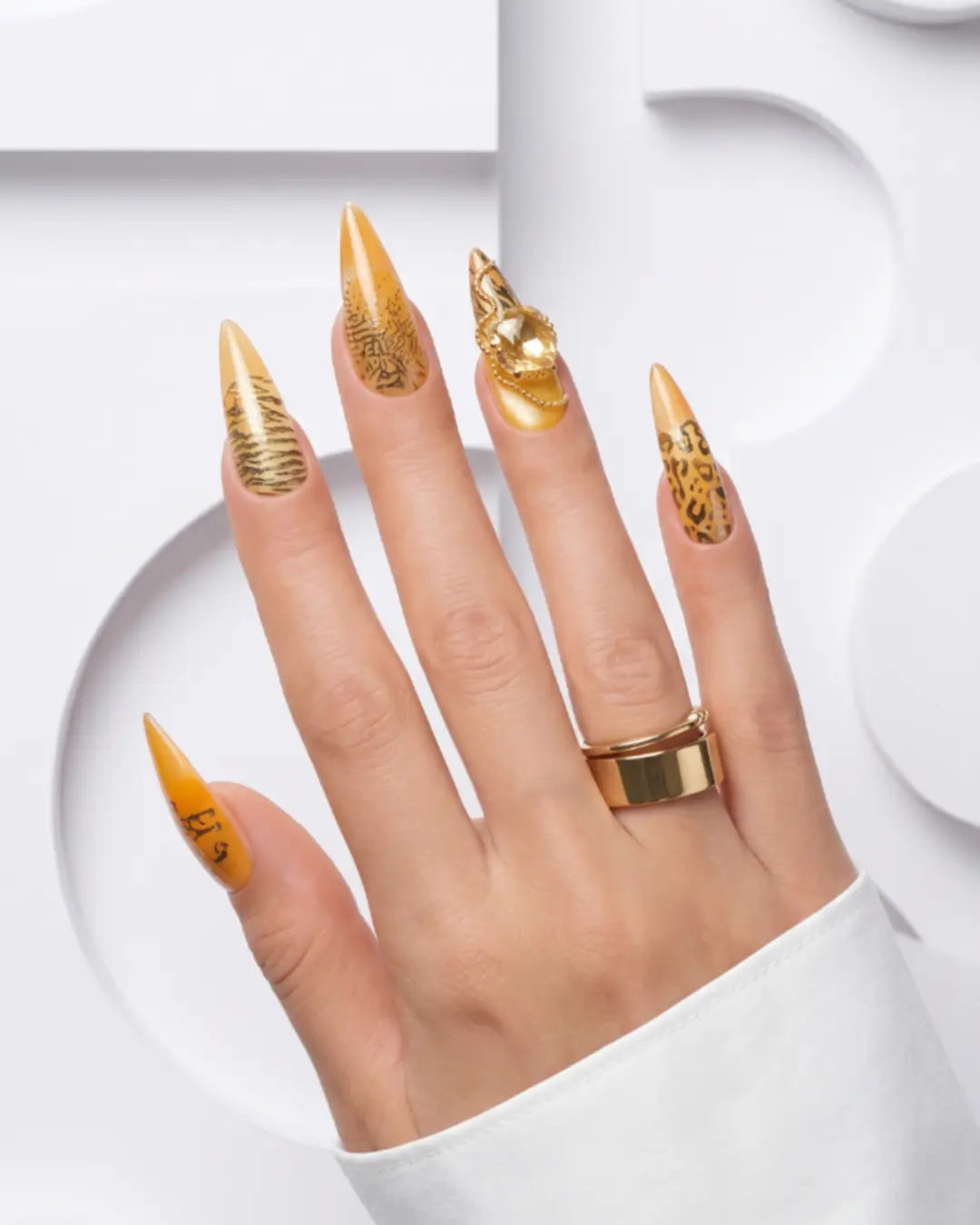 Luxury medium almond press-on nails with translucent amber glass French tips, elegant animal-print accents, and gold detailing in a high-gloss gel finish.