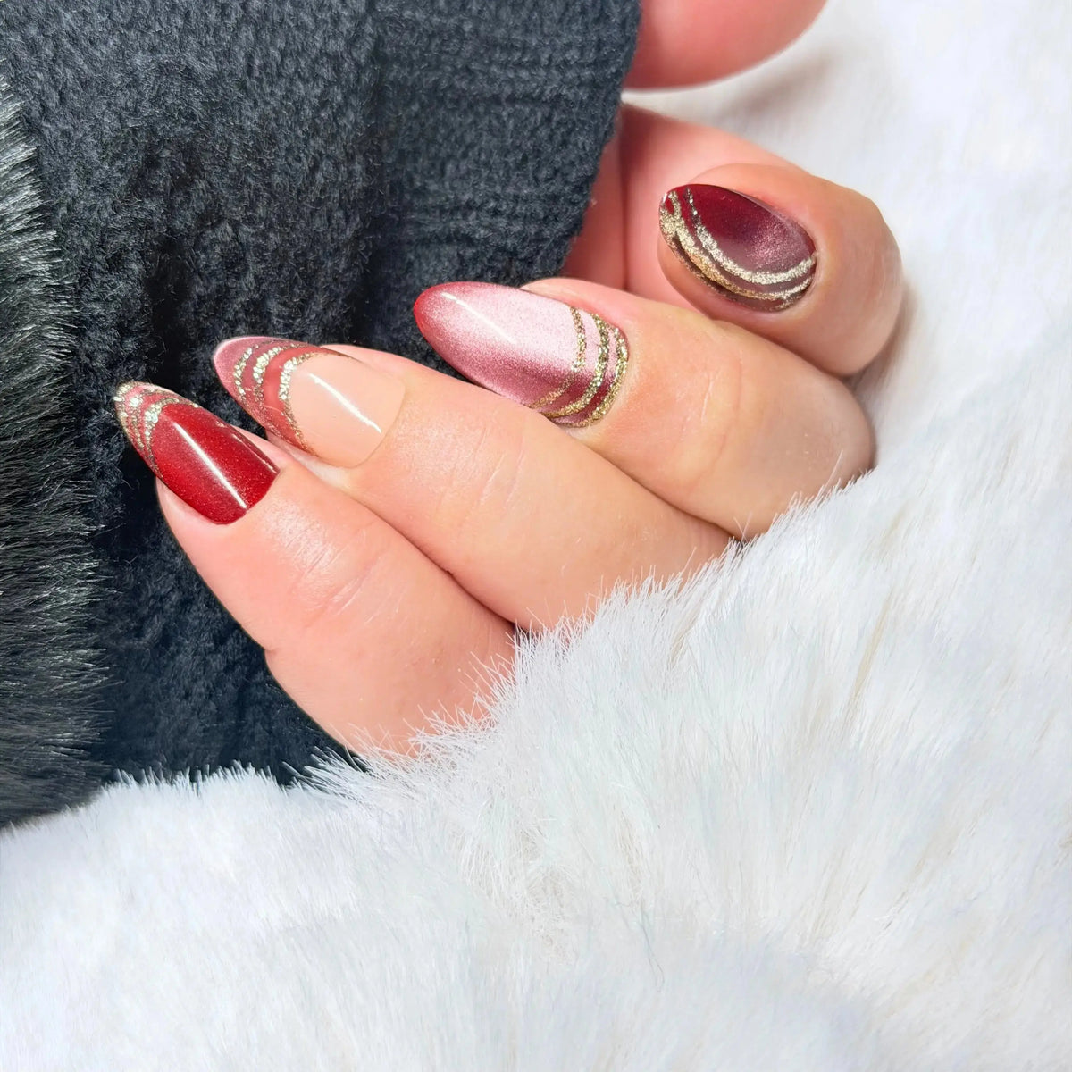 Red Thread handmade burgundy and blush cat-eye press-on nails with fine flowing lines and sheer negative-space details