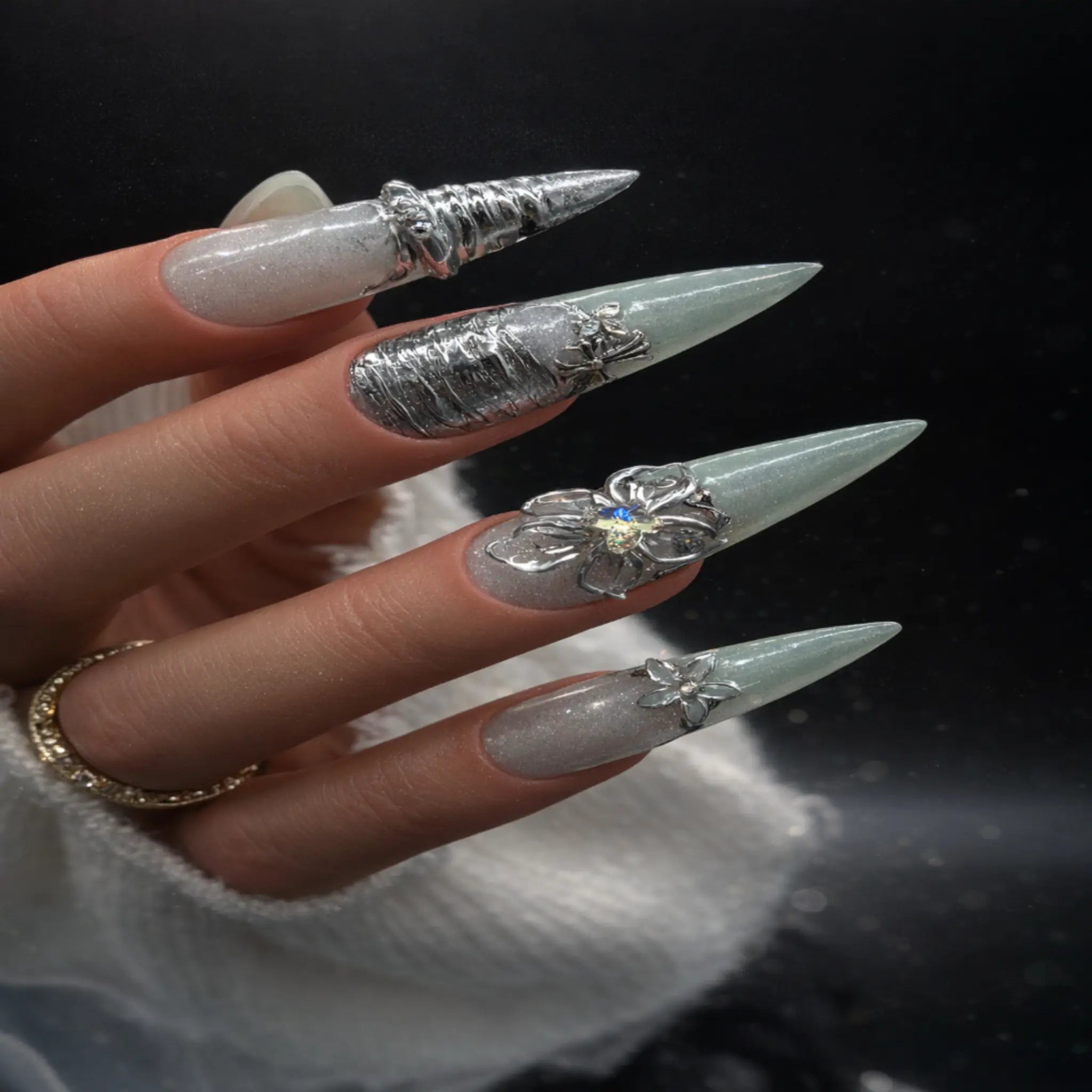 Silver chrome floral stiletto press-on nails with sage green and milky nude base, featuring 3D flowers and metallic swirl accents