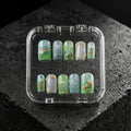 Verdant Elixir green floral press-on nails, glossy jade and aqua marble design with gold accents, luxury handmade nail set in clear case