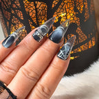 Midnight Web stiletto nail art with silver glitter and spiderweb details