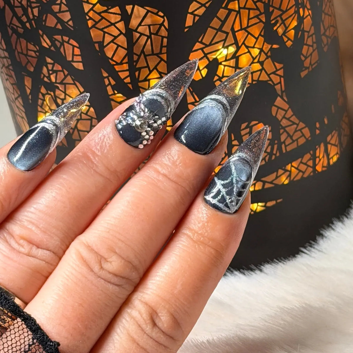 Midnight Web stiletto nail art with silver glitter and spiderweb details