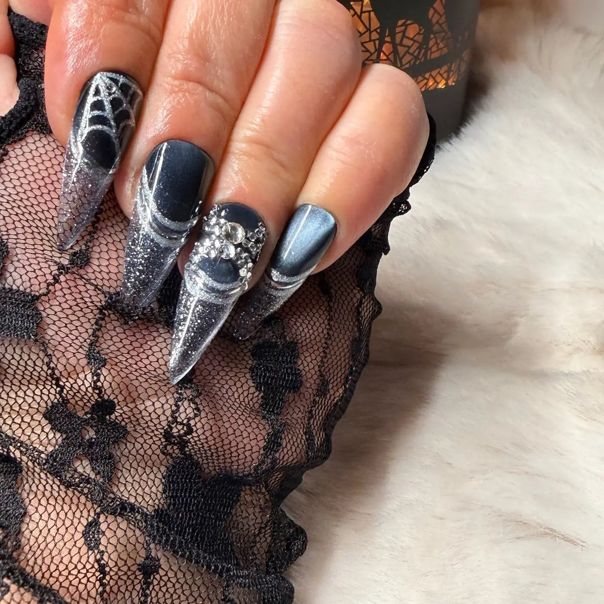 Silver spiderweb and crystal nail art close-up on Midnight Web
