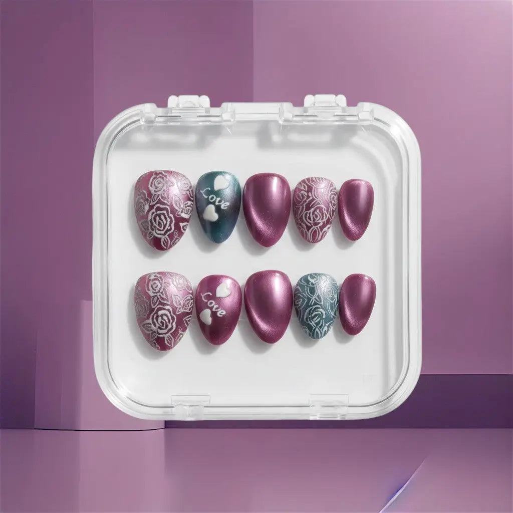 Press to Impress Amour Bloom press-on nails with rose art, love hearts, and ombré gradients in mauve, plum, and teal.