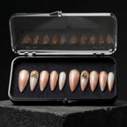 Press to Impress Antigua luxury press-on nails with champagne shimmer, ivory accents, and gold glitter embellishments.