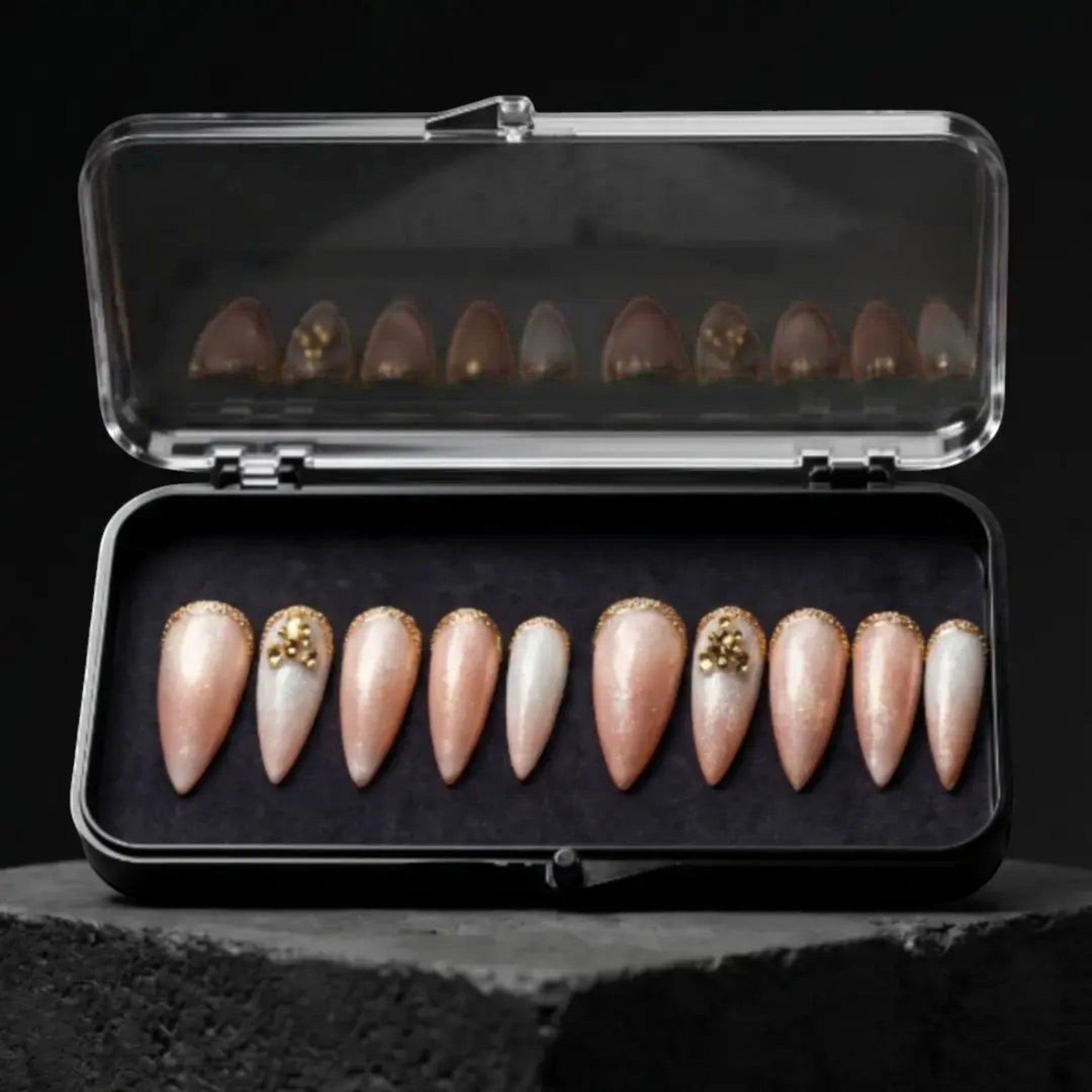 Press to Impress Antigua luxury press-on nails with champagne shimmer, ivory accents, and gold glitter embellishments.