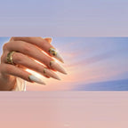 Press to Impress Antigua stiletto press-on nails with champagne shimmer, pearlescent ivory, and gold glitter accents.