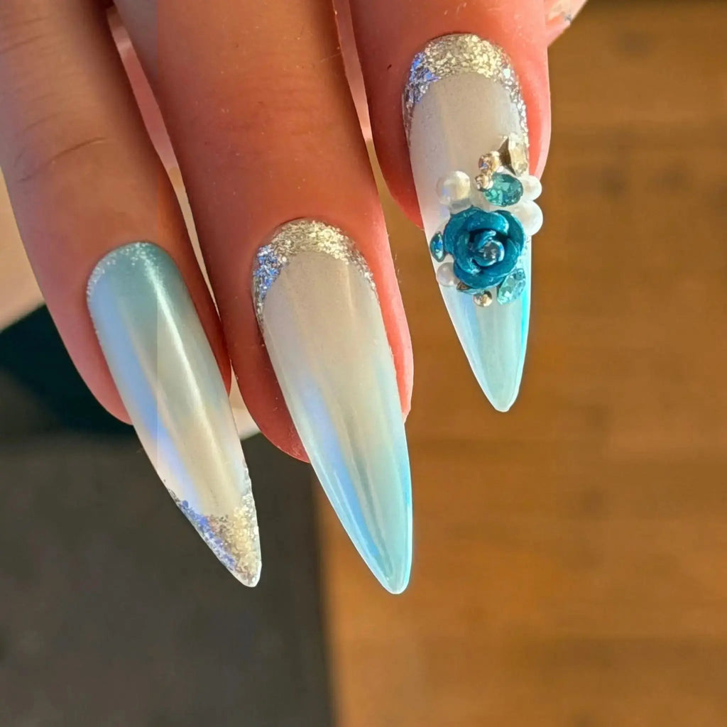 Press to Impress Aruba luxury press-on nails with blue ombré, pearlescent white, 3D floral accents, and silver glitter.
