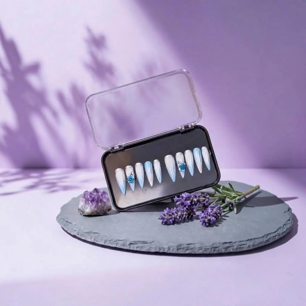 Press to Impress Aruba luxury press-on nails featuring blue ombré, pearlescent shimmer, 3D floral accents, and glitter.