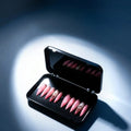 Press to Impress Barbados pearlescent pink press-on nails with silver glitter and crystal accents in a black case.