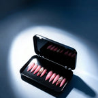 Press to Impress Barbados pearlescent pink press-on nails with silver glitter and crystal accents in a black case.