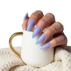 Press to Impress Blue Haze stiletto press-on nails in translucent sky blue with glossy finish and gradient purple undertones.