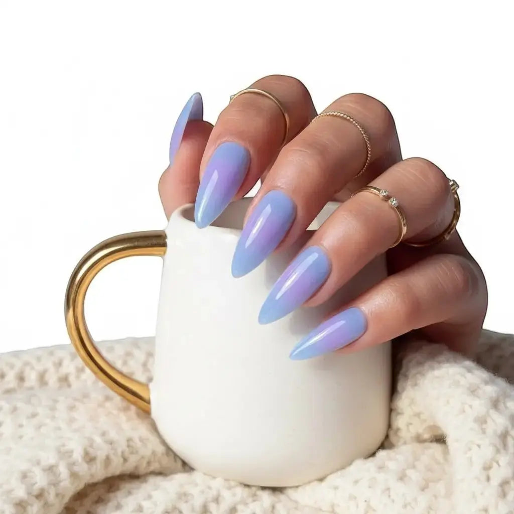 Press to Impress Blue Haze stiletto press-on nails in translucent sky blue with glossy finish and gradient purple undertones.