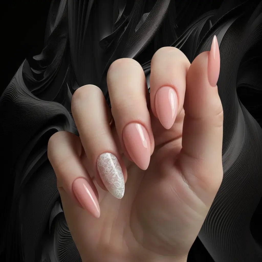Press to Impress sheer blush nude almond nails with delicate white lace accent on one nail.
