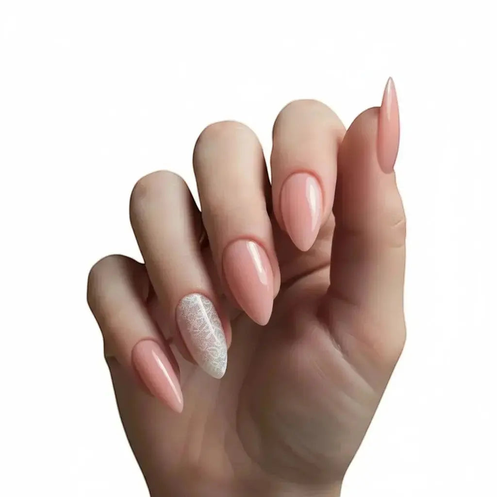 Press to Impress sheer blush nude almond nails with delicate white lace accent on one nail.