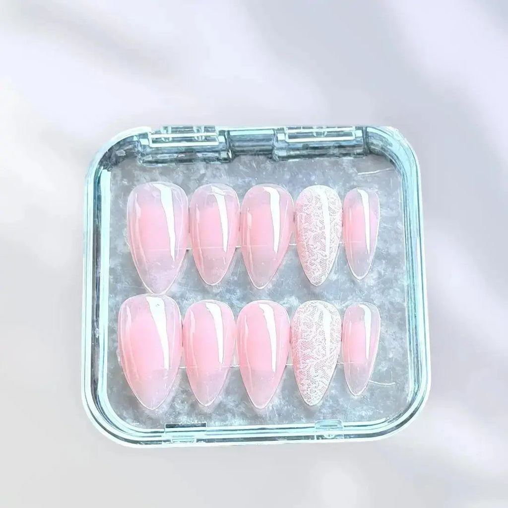 Press to Impress sheer blush nude almond press-on nails with delicate white lace detailing. Romantic and feminine.