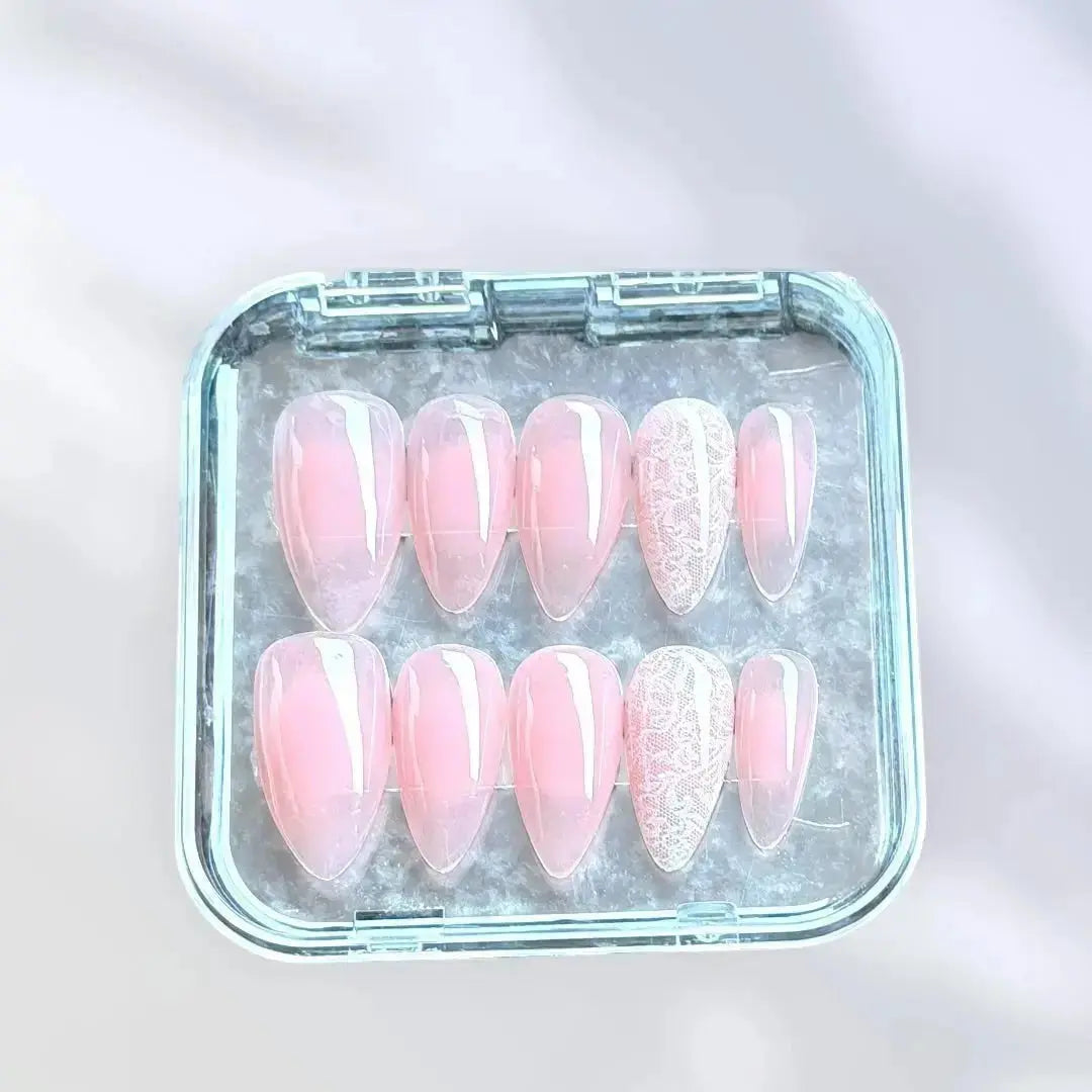 Press to Impress sheer blush nude almond press-on nails with delicate white lace detailing. Romantic and feminine.