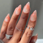 Press to Impress Dew Kiss peachy nude stiletto nails with glossy water droplet accents and a sheer finish.
