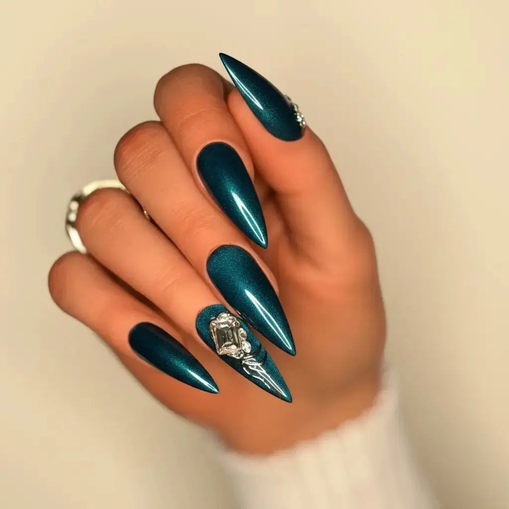 Press to Impress Emerald Eclipse stiletto press-on nails with metallic emerald finish and crystal accent.