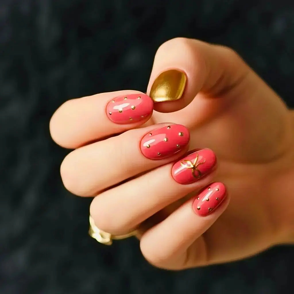 Press to Impress Gilded Rose Stud short press-on nails in dry rose pink with gold studs and one gold accent nail.