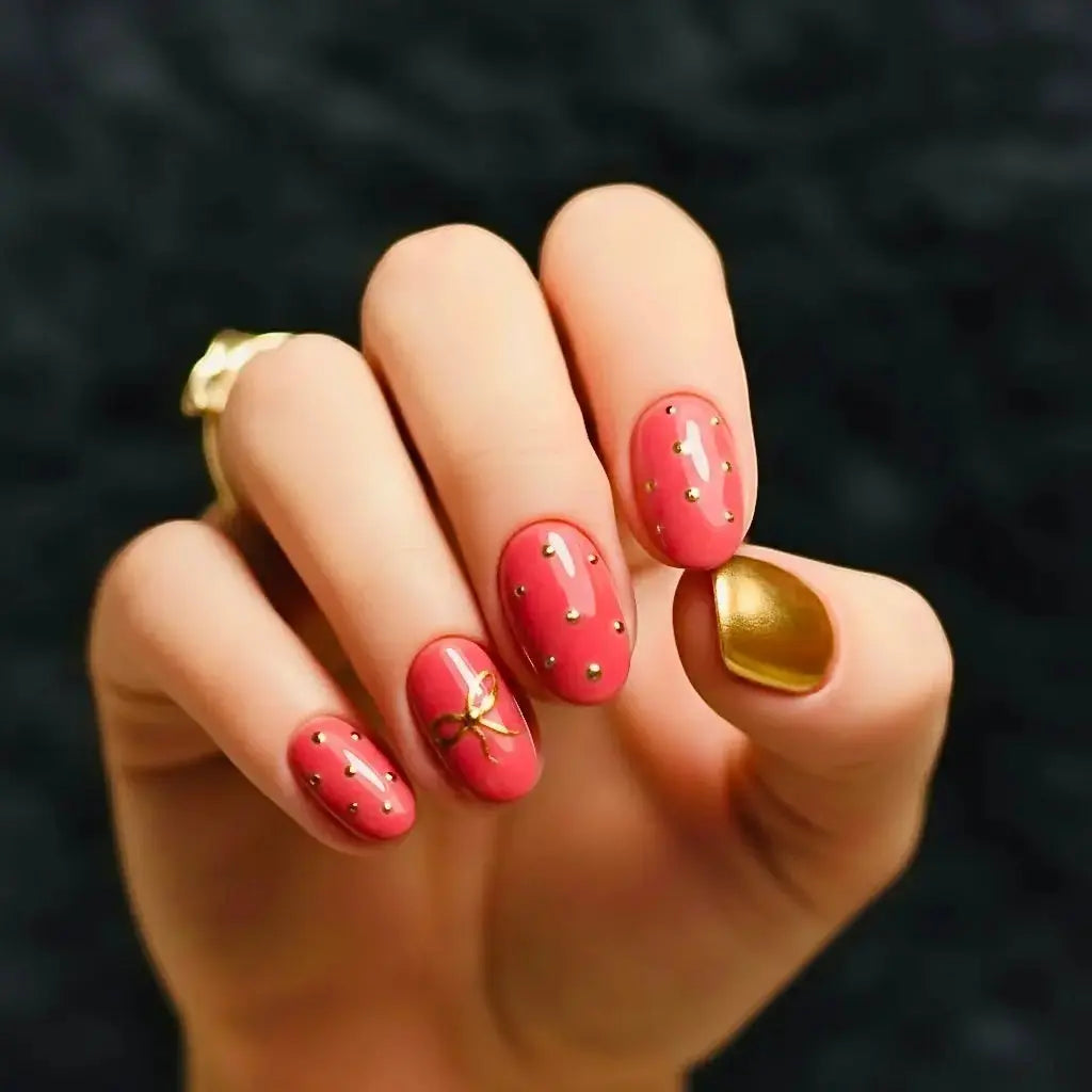 Press to Impress Gilded Rose Stud luxury press-on nails in dry rose pink with gold studs and a gold accent nail.
