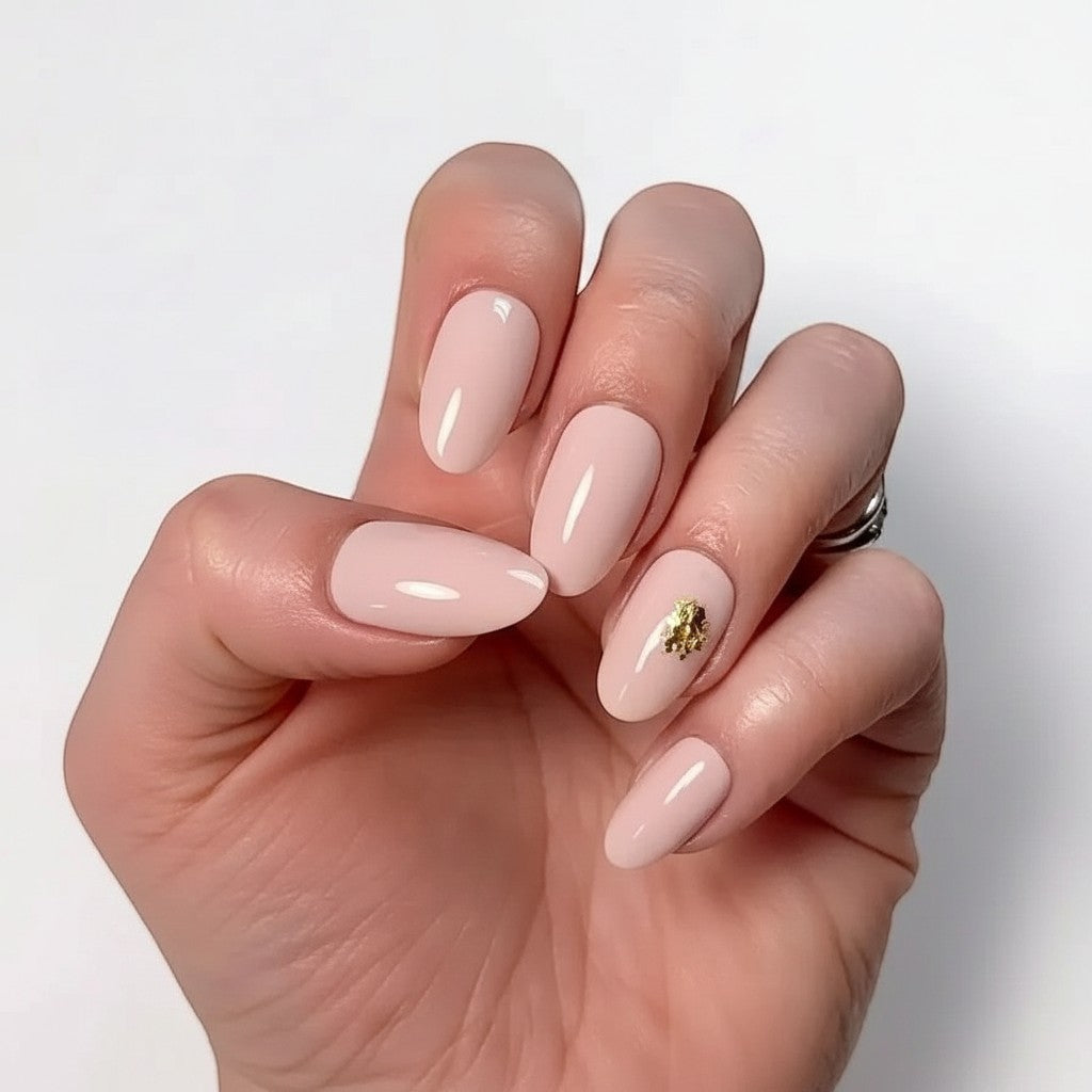 Press to Impress Gilded Whisper press on nails: soft pink nude with gold flakes, short round shape.