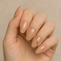 Press to Impress Golden Hour Beige short round press-on nails with a gold line accent. Clean girl aesthetic.