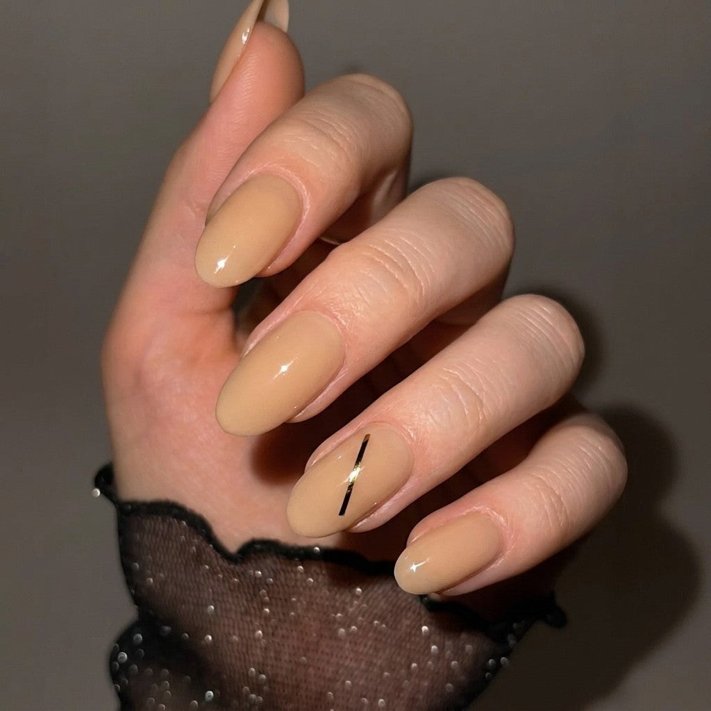 Press to Impress Golden Hour Beige short round press-on nails with a gold line accent. Clean girl aesthetic.