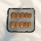 Press to Impress Golden Hour Beige short round press-on nails with a gold line accent. Set of 10.