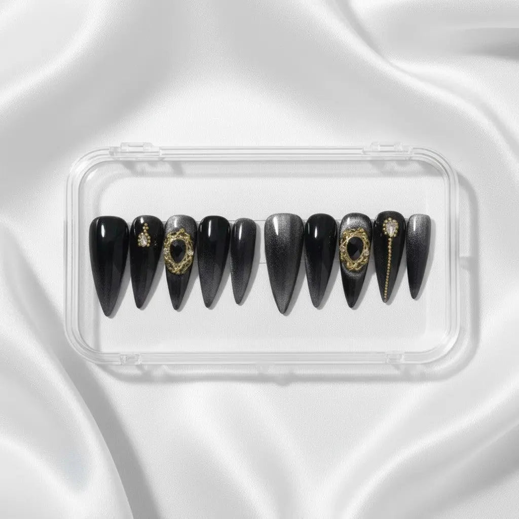 Press to Impress Golden Obsidian luxury press on nails in black with gold accents and cat eye finish. Stiletto shape.
