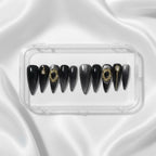 Press to Impress Golden Obsidian luxury press on nails in black with gold accents and cat eye finish. Stiletto shape.