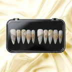 Press to Impress Golden Veins press on nails, matte white with gold accents and crystal clusters. Stiletto shape.