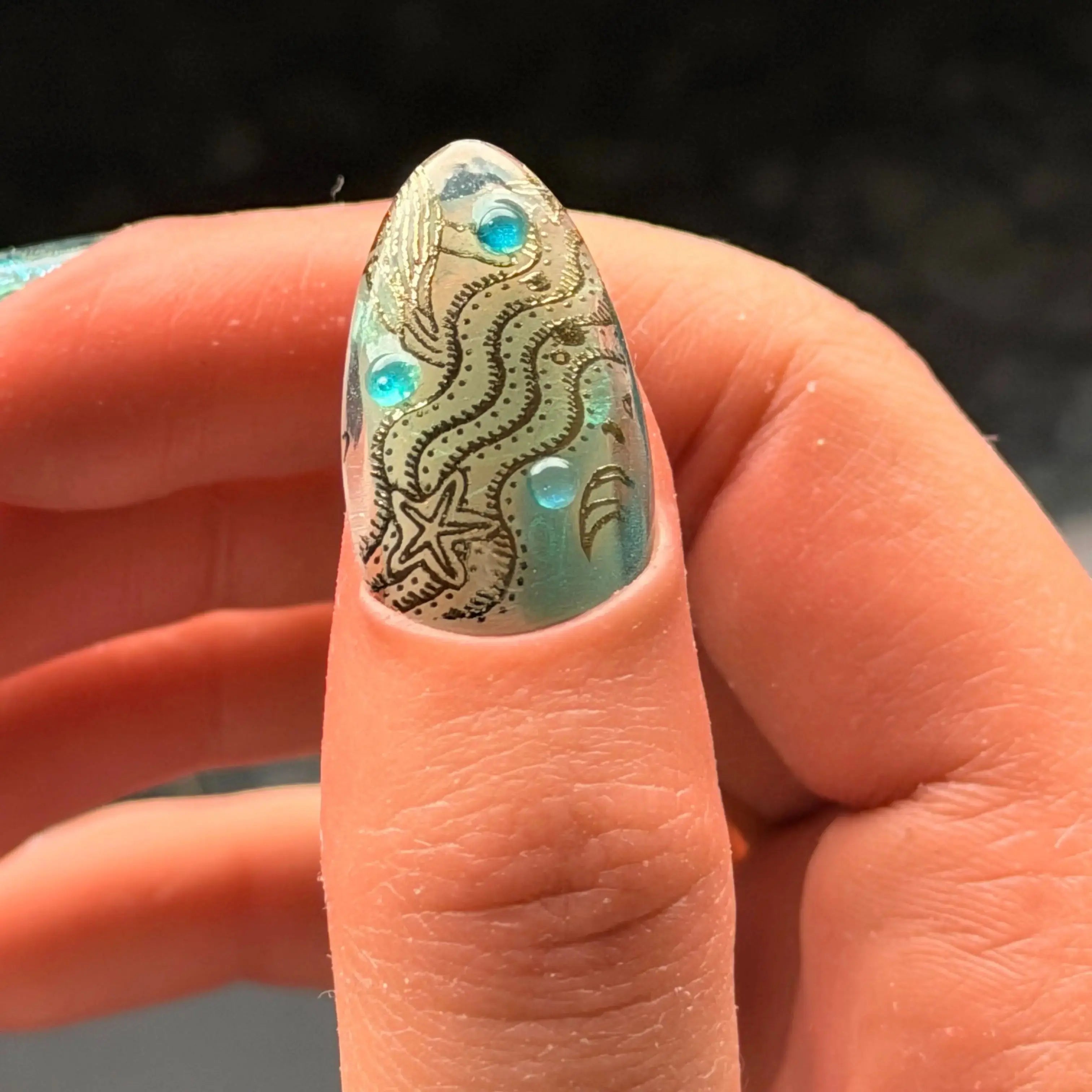Press to Impress Lost Atlantis luxury press-on nail with seafoam chrome, gold ocean details, starfish, and blue gems.