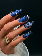 Press to Impress Midnight Sapphire luxury press-on nails with cat eye effect, 3D flower, crystals, and metallic accents.