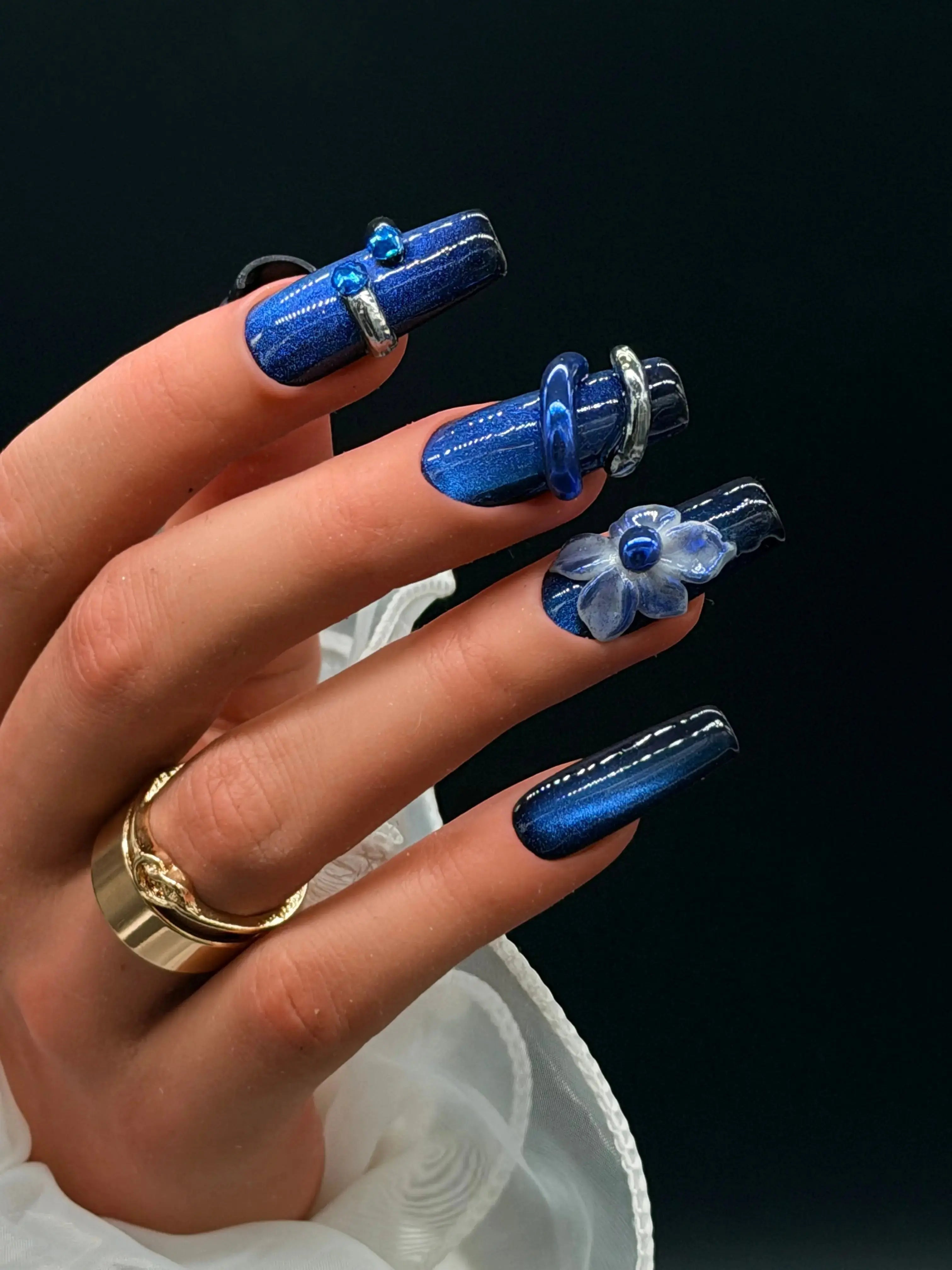 Press to Impress Midnight Sapphire luxury press-on nails with cat eye effect, 3D flower, crystals, and metallic accents.
