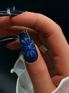 Press to Impress Midnight Sapphire press-on nails with 3D blue flower and cat eye effect.