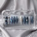 Press to Impress Midnight Spell press on nails feature a mix of midnight blue, holographic, and lace designs. Stiletto shape.