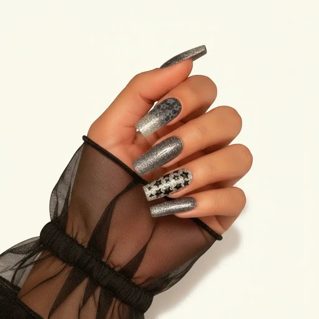 Press to Impress long square black micro-glitter nails with silver sparkle and black star accent nails.