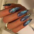 Press to Impress Mystic Galaxy stiletto nails in midnight blue with violet undertones, cat-eye shift, and glitter accents.