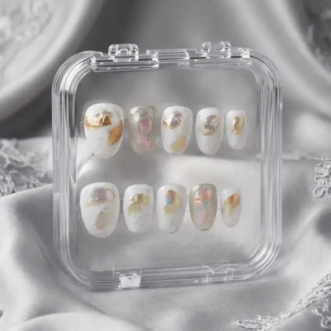 Press to Impress Opaline Reverie press-on nails: milky white with gold foil and iridescent accents, velvety finish.