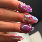 Press to Impress Orchid Mirage iridescent chrome nails with sculpted floral accents and crystals in violet hues.