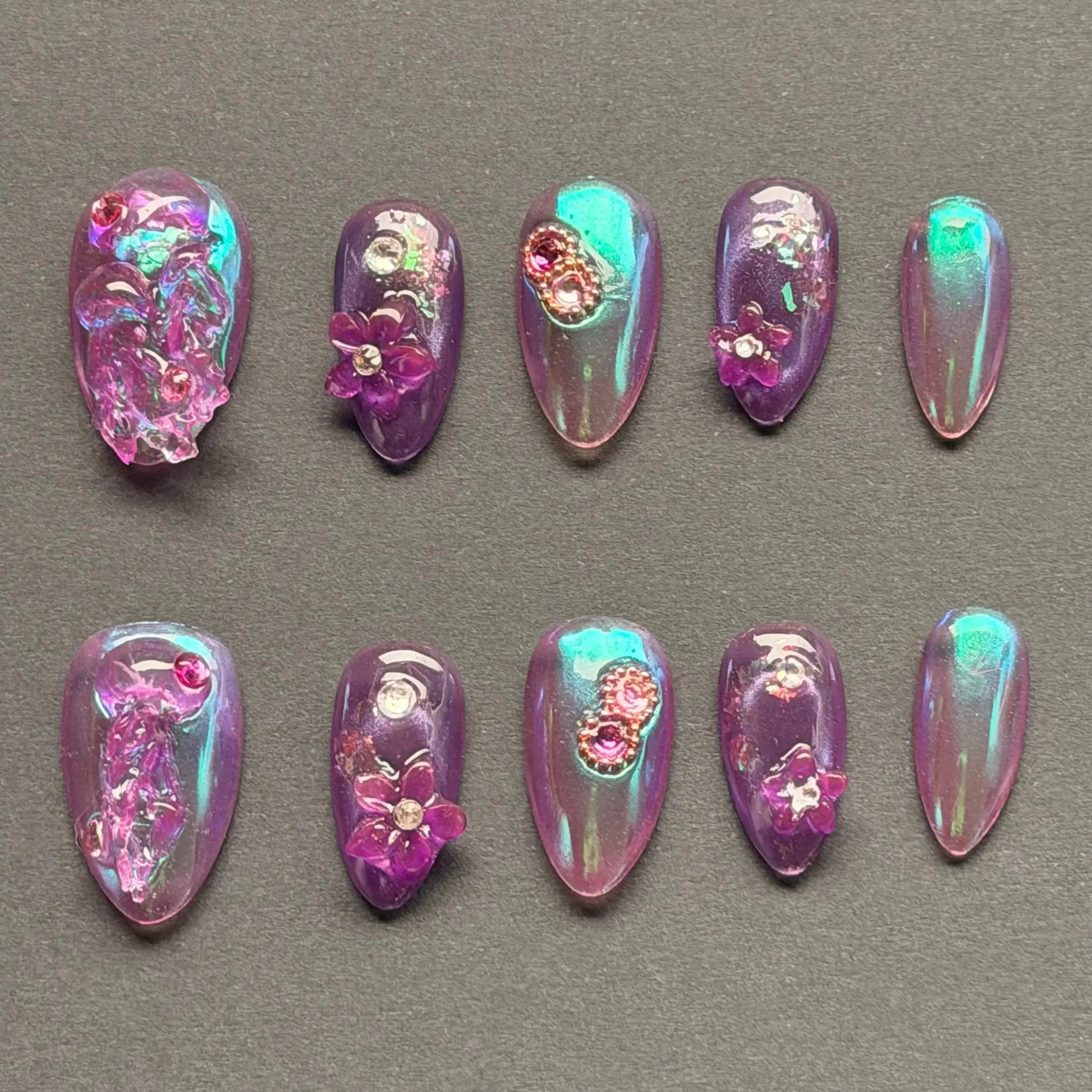Press to Impress Orchid Mirage iridescent chrome press-on nails with sculpted florals and crystal embellishments in violet hues.