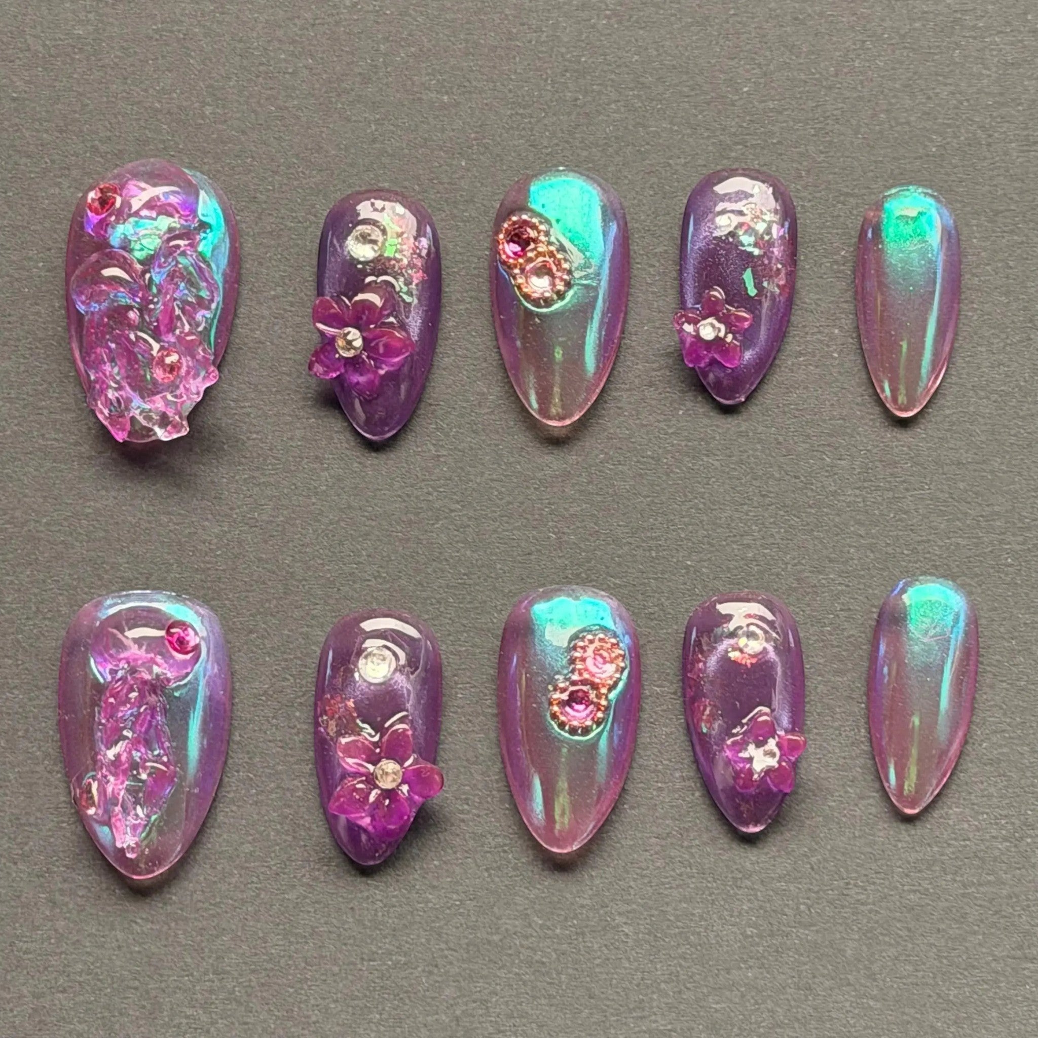 Press to Impress Orchid Mirage iridescent chrome press-on nails with sculpted florals and crystal embellishments in violet hues.