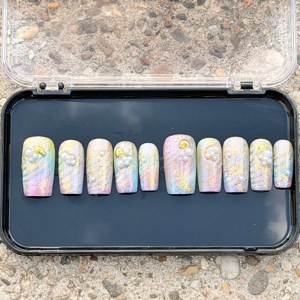 Press to Impress Pastel Mermaid Pearl Press-On Nails with iridescent chrome finish, pastel hues, pearls, and gold shell accents.