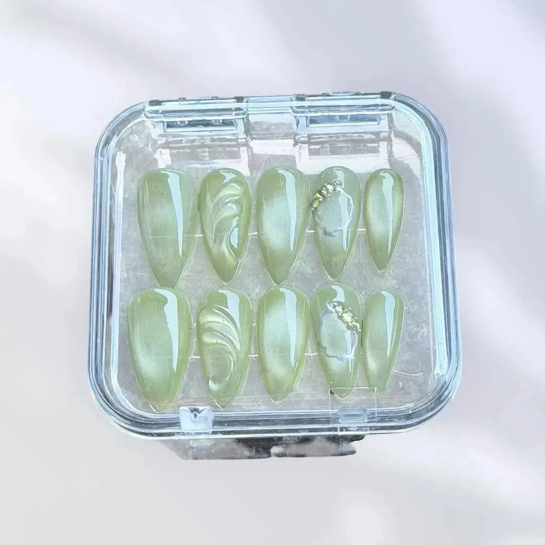 Press to Impress Pistachio Veil press-on nails with luminous shimmer, translucent detailing, and rhinestone accents.